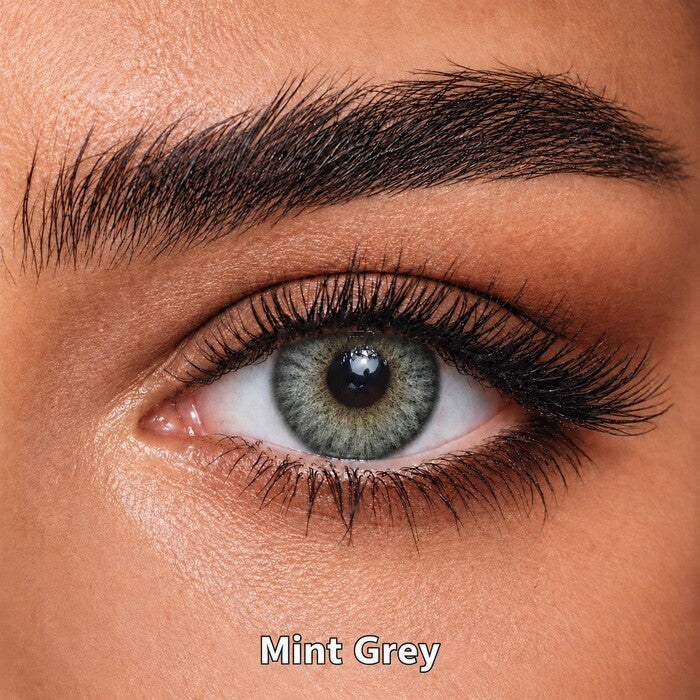 Bella Elite Collection Mint Grey coloured contact lens worn on a brown eye