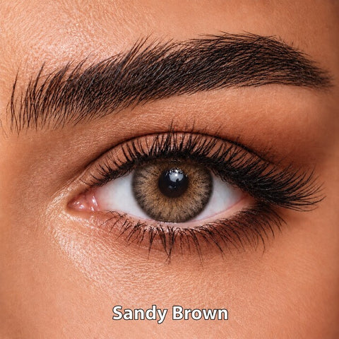 Bella Elite Collection Sandy Brown coloured contact lens worn on a brown eye
