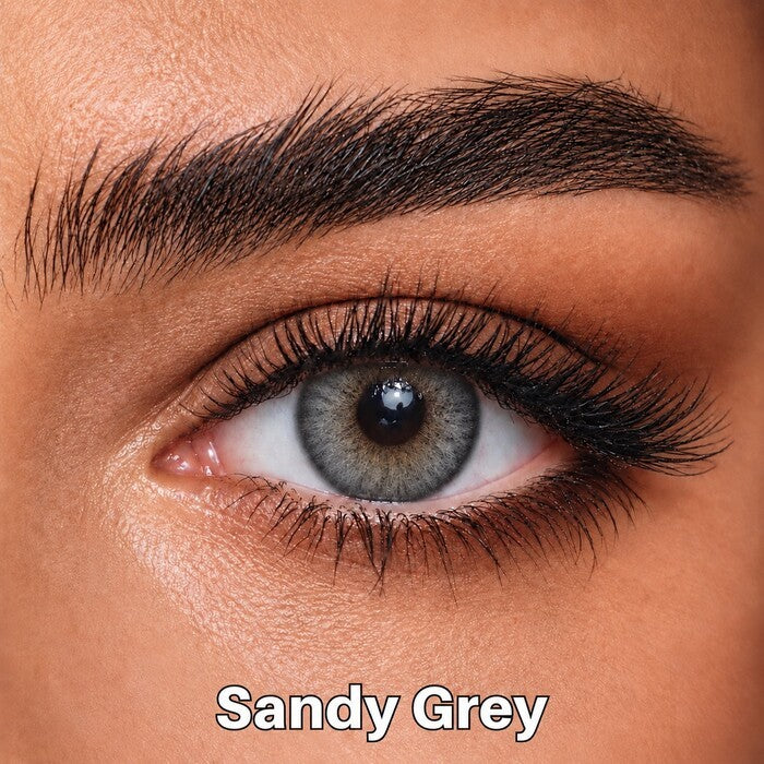 Bella Elite Collection Sandy Grey coloured contact lens worn on a brown eye