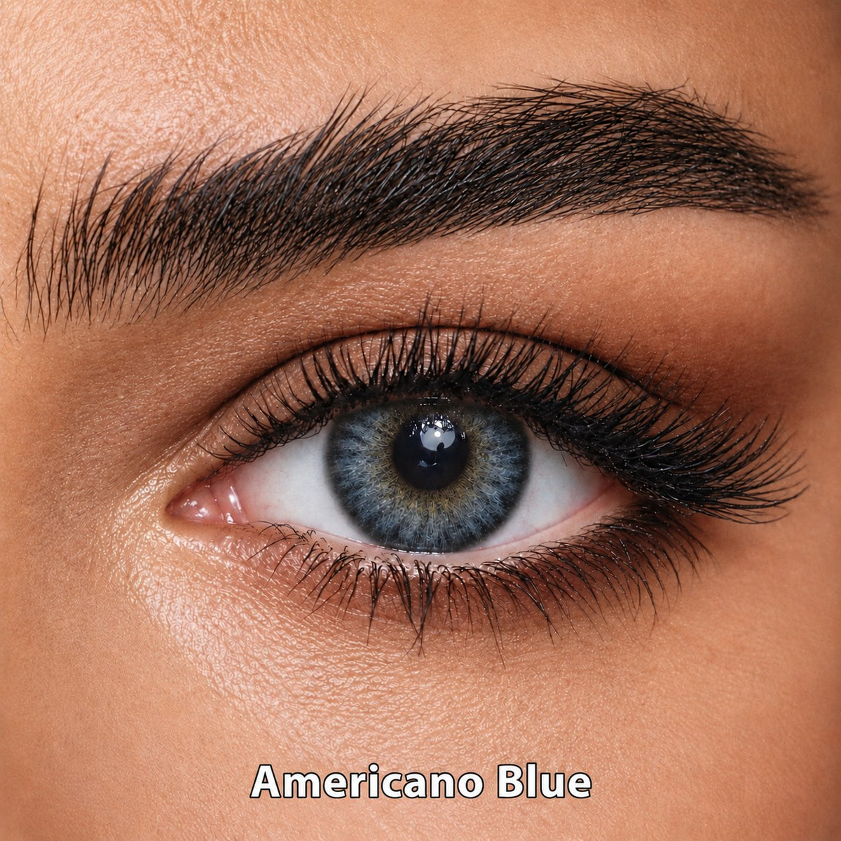 FreshKon Naho Americano Blue coloured contact lens worn on a brown eye