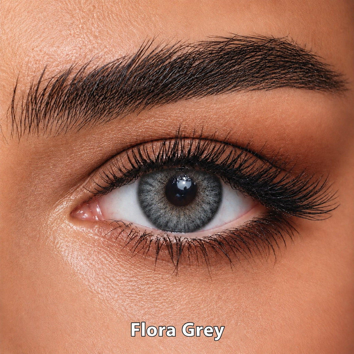 FreshKon Naho Flora Grey coloured contact lens worn on a brown eye
